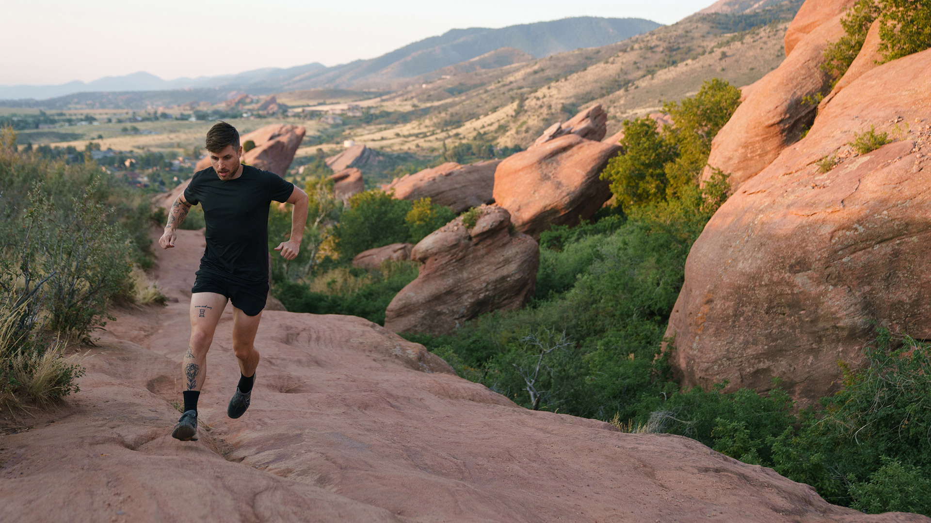 runner runs along trail in canyon