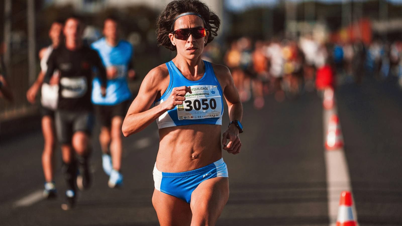 Triathlete running during a race, demonstrating endurance and pacing strategy in the final leg of a triathlon
