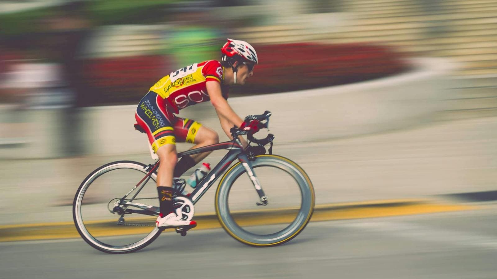 cyclist practicing cornering body position on indoor trainer to improve technique and stability