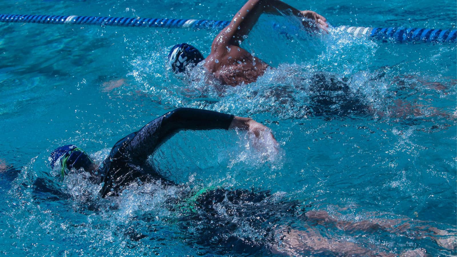 new triathlete learning breathing technique and body position during swim training session
