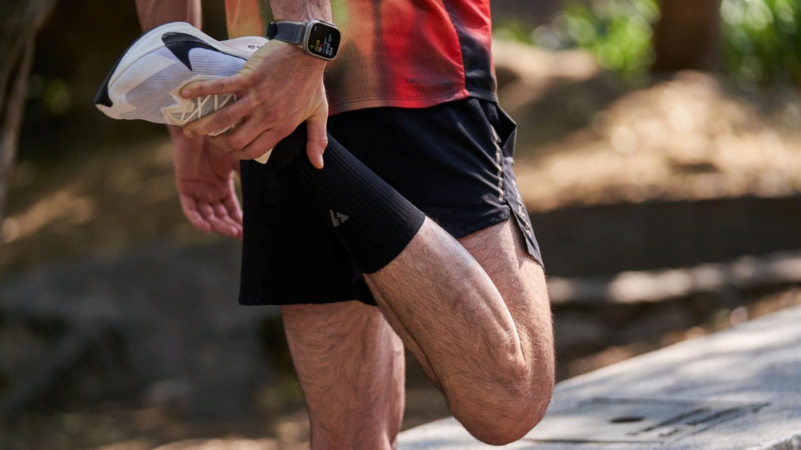 triathlete applying recovery methods for shin splints after swim bike and run training session