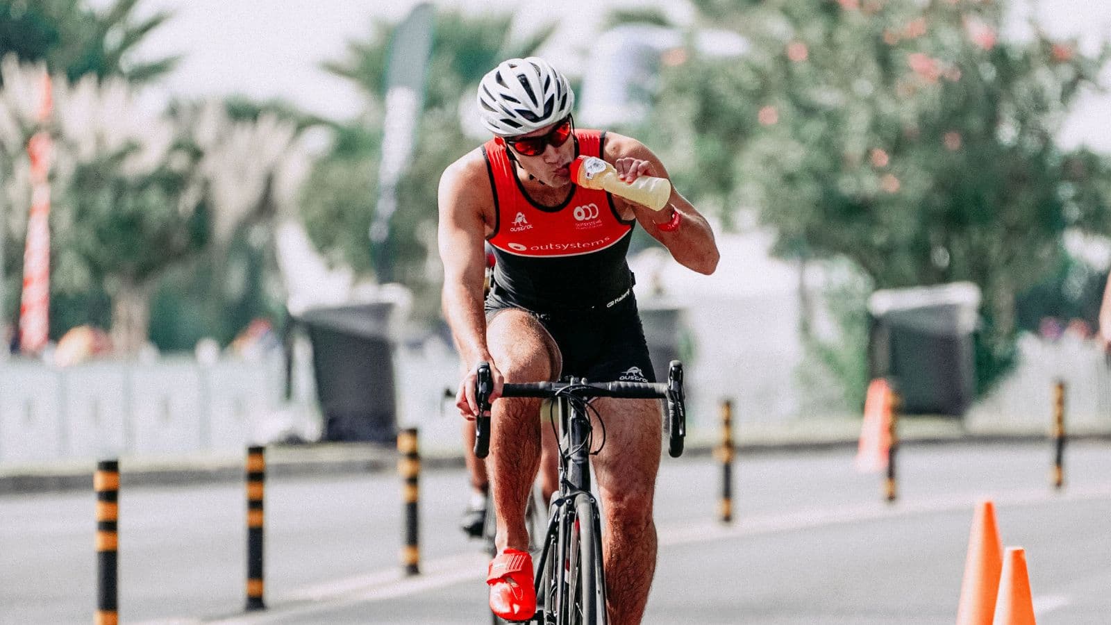 runner holding energy gels and sports nutrition products during endurance training session